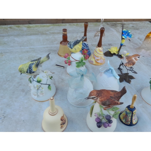 77 - Porcelain and pottery bells, birds by Peter Barrett, Parian Lladro bells , Bouchet pottery etc.