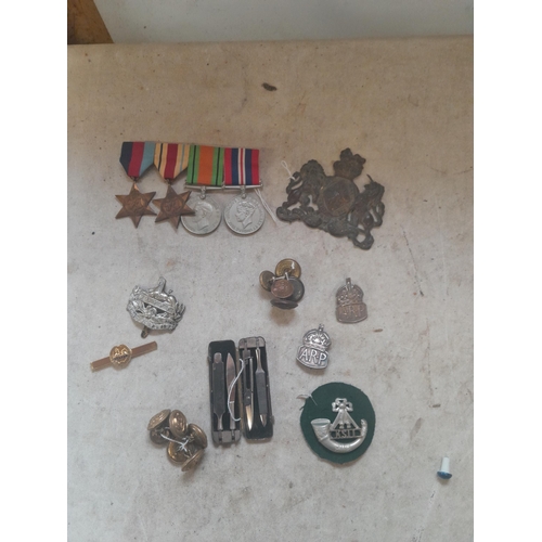 428 - Militaria : cap and arm badges, World War II medal set , buttons and pips, and related items