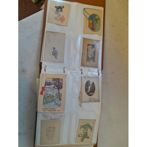 107 - Array of approx 200 greeting cards from early - mid 20th century in an album with two further empty ... 