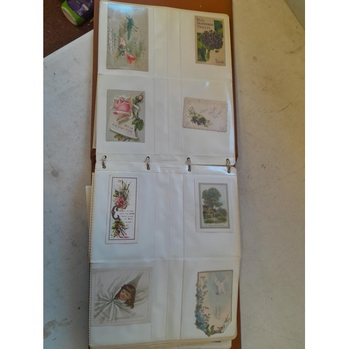 107 - Array of approx 200 greeting cards from early - mid 20th century in an album with two further empty ... 