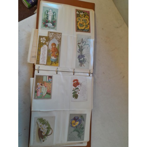 107 - Array of approx 200 greeting cards from early - mid 20th century in an album with two further empty ... 