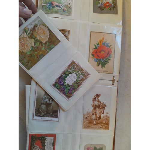 107 - Array of approx 200 greeting cards from early - mid 20th century in an album with two further empty ... 