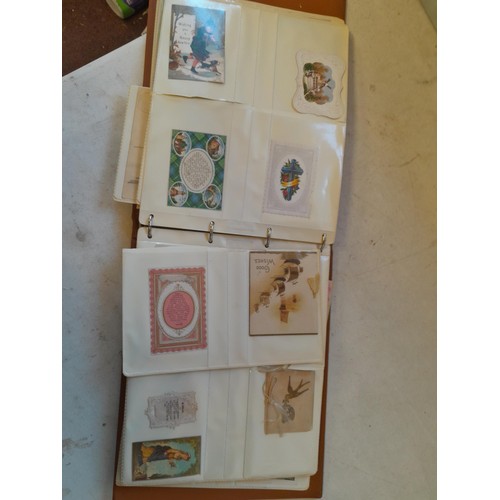 107 - Array of approx 200 greeting cards from early - mid 20th century in an album with two further empty ... 