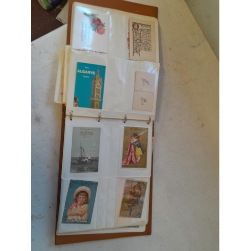 107 - Array of approx 200 greeting cards from early - mid 20th century in an album with two further empty ... 