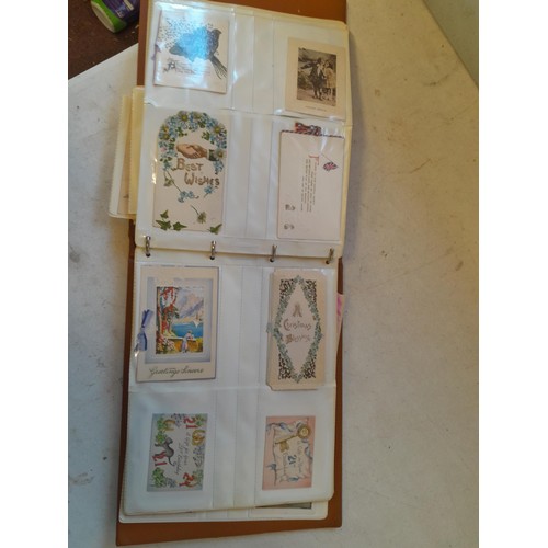 107 - Array of approx 200 greeting cards from early - mid 20th century in an album with two further empty ... 