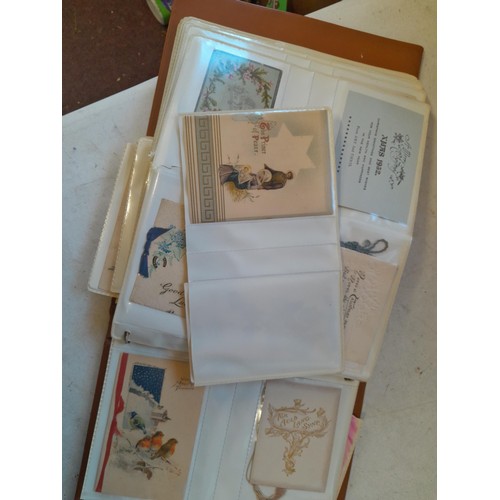 107 - Array of approx 200 greeting cards from early - mid 20th century in an album with two further empty ... 