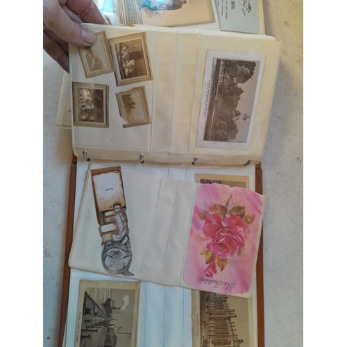 107 - Array of approx 200 greeting cards from early - mid 20th century in an album with two further empty ... 