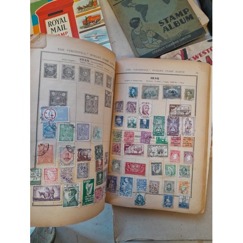 114 - Stamps : a varied collection of mainly used stamps of the world in a variety of albums, schoolboy co... 