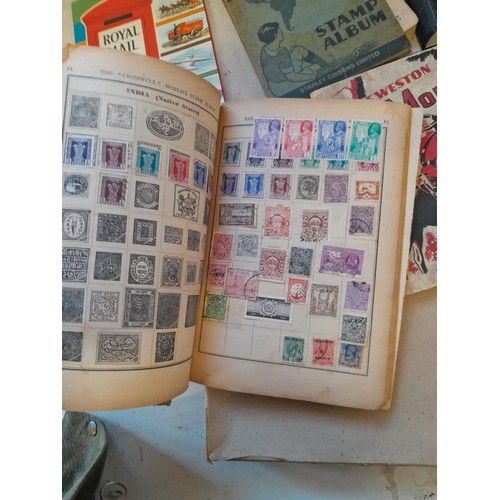 114 - Stamps : a varied collection of mainly used stamps of the world in a variety of albums, schoolboy co... 