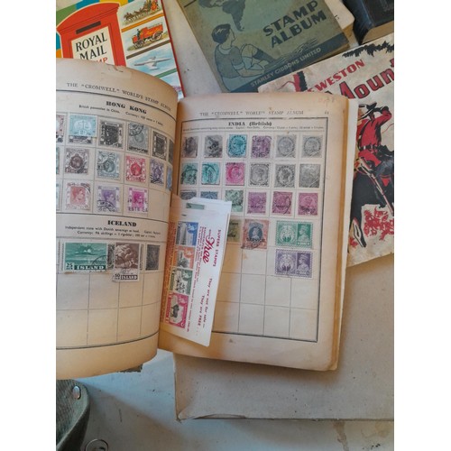 114 - Stamps : a varied collection of mainly used stamps of the world in a variety of albums, schoolboy co... 