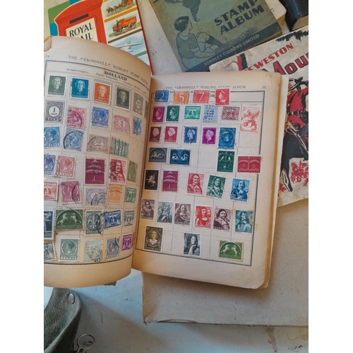 114 - Stamps : a varied collection of mainly used stamps of the world in a variety of albums, schoolboy co... 