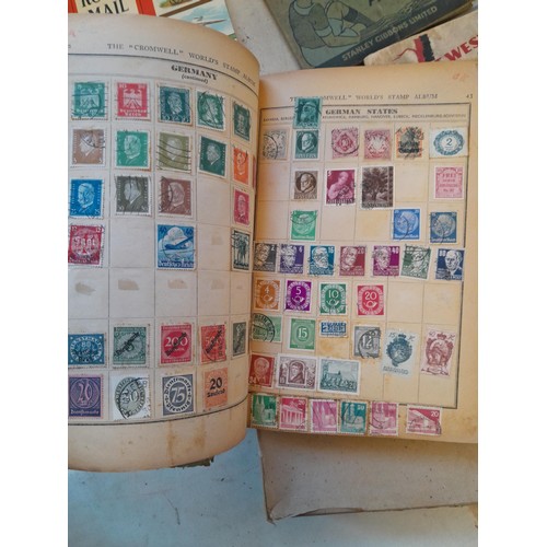 114 - Stamps : a varied collection of mainly used stamps of the world in a variety of albums, schoolboy co... 