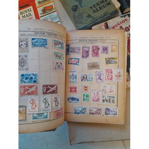 114 - Stamps : a varied collection of mainly used stamps of the world in a variety of albums, schoolboy co... 