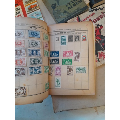 114 - Stamps : a varied collection of mainly used stamps of the world in a variety of albums, schoolboy co... 