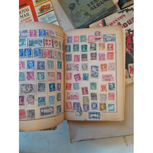 114 - Stamps : a varied collection of mainly used stamps of the world in a variety of albums, schoolboy co... 