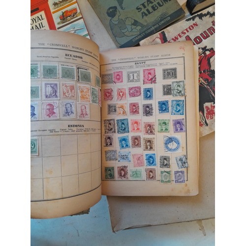 114 - Stamps : a varied collection of mainly used stamps of the world in a variety of albums, schoolboy co... 