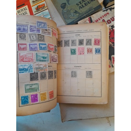 114 - Stamps : a varied collection of mainly used stamps of the world in a variety of albums, schoolboy co... 