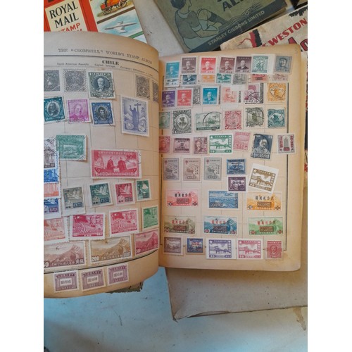 114 - Stamps : a varied collection of mainly used stamps of the world in a variety of albums, schoolboy co... 