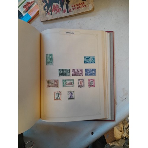 114 - Stamps : a varied collection of mainly used stamps of the world in a variety of albums, schoolboy co... 