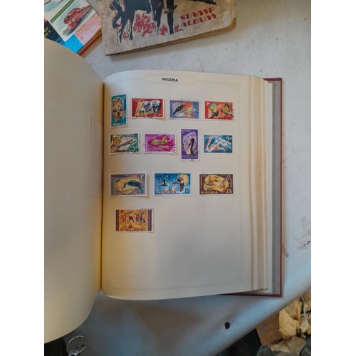 114 - Stamps : a varied collection of mainly used stamps of the world in a variety of albums, schoolboy co... 