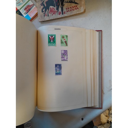 114 - Stamps : a varied collection of mainly used stamps of the world in a variety of albums, schoolboy co... 