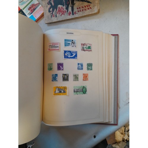 114 - Stamps : a varied collection of mainly used stamps of the world in a variety of albums, schoolboy co... 