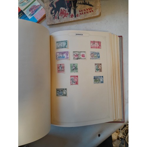 114 - Stamps : a varied collection of mainly used stamps of the world in a variety of albums, schoolboy co... 