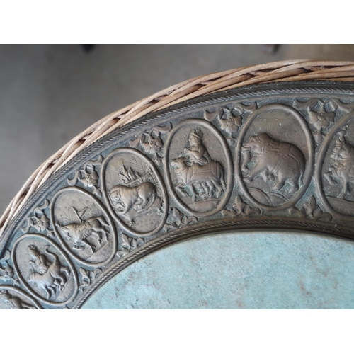 49 - An interesting vintage Indian wicker table with hardstone panel and repouse work brass relief of pan... 