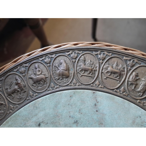 49 - An interesting vintage Indian wicker table with hardstone panel and repouse work brass relief of pan... 
