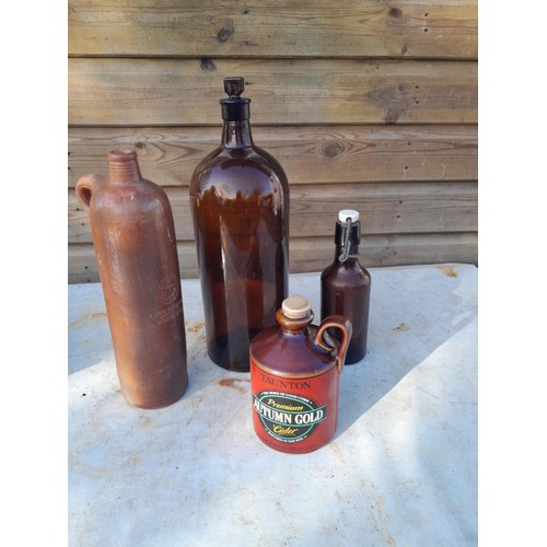 14 - Advertising and non advertising stoneware flagons, bread bin, chip on rim