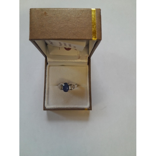67 - Unmarked but test 18 ct white gold ring set with sapphire and surrounded with diamonds size M gross ... 
