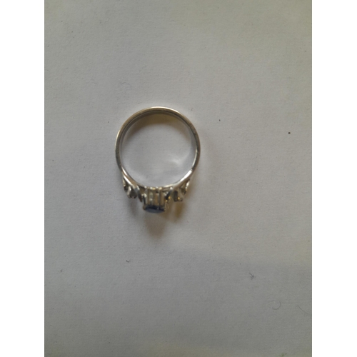 67 - Unmarked but test 18 ct white gold ring set with sapphire and surrounded with diamonds size M gross ... 