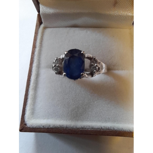 67 - Unmarked but test 18 ct white gold ring set with sapphire and surrounded with diamonds size M gross ... 