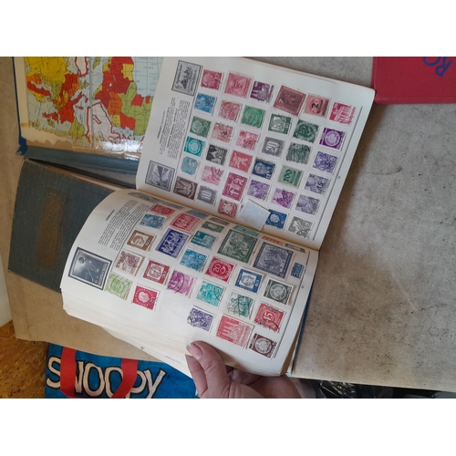 136 - Stamps: a box of stamps albums, ice cream carton of stamps on paper and loose, mixed era world stamp... 