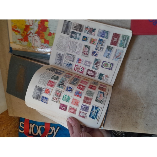 136 - Stamps: a box of stamps albums, ice cream carton of stamps on paper and loose, mixed era world stamp... 