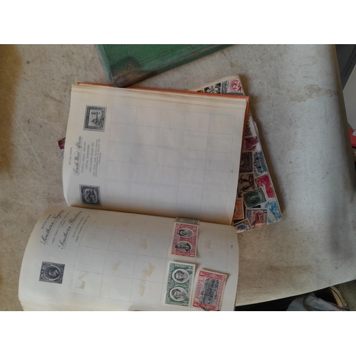 136 - Stamps: a box of stamps albums, ice cream carton of stamps on paper and loose, mixed era world stamp... 