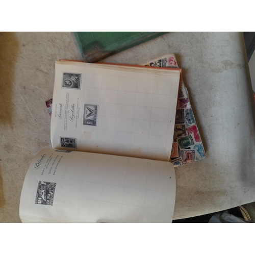 136 - Stamps: a box of stamps albums, ice cream carton of stamps on paper and loose, mixed era world stamp... 