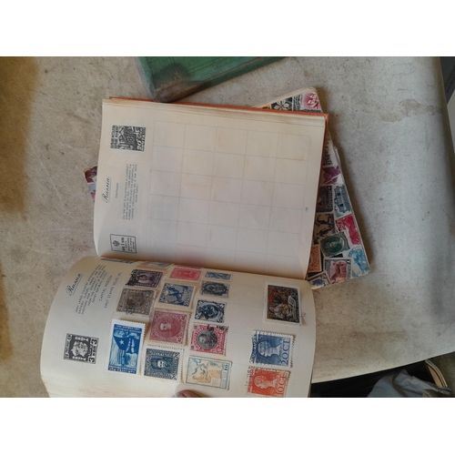 136 - Stamps: a box of stamps albums, ice cream carton of stamps on paper and loose, mixed era world stamp... 