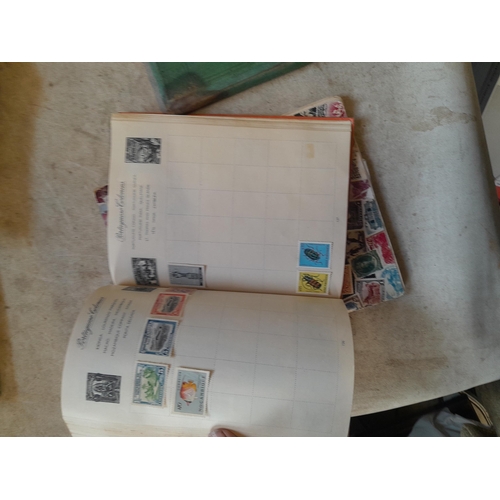 136 - Stamps: a box of stamps albums, ice cream carton of stamps on paper and loose, mixed era world stamp... 