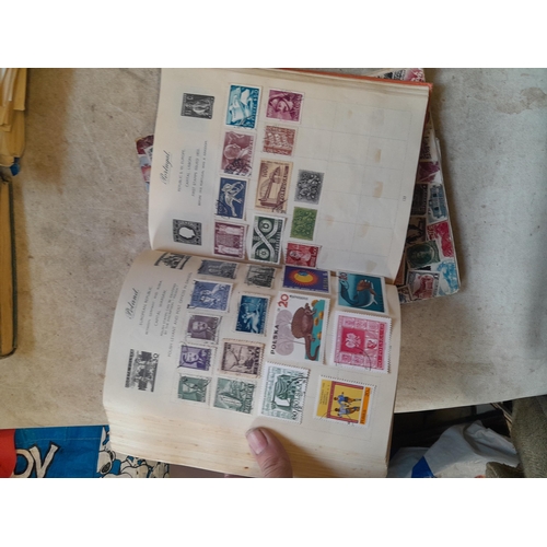 136 - Stamps: a box of stamps albums, ice cream carton of stamps on paper and loose, mixed era world stamp... 