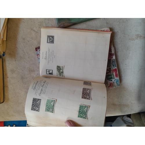 136 - Stamps: a box of stamps albums, ice cream carton of stamps on paper and loose, mixed era world stamp... 