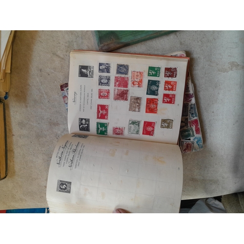 136 - Stamps: a box of stamps albums, ice cream carton of stamps on paper and loose, mixed era world stamp... 