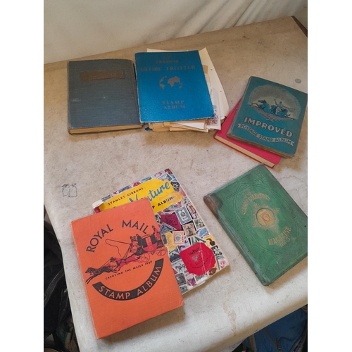 136 - Stamps: a box of stamps albums, ice cream carton of stamps on paper and loose, mixed era world stamp... 