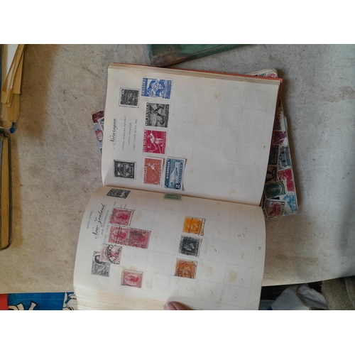 136 - Stamps: a box of stamps albums, ice cream carton of stamps on paper and loose, mixed era world stamp... 
