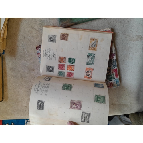 136 - Stamps: a box of stamps albums, ice cream carton of stamps on paper and loose, mixed era world stamp... 