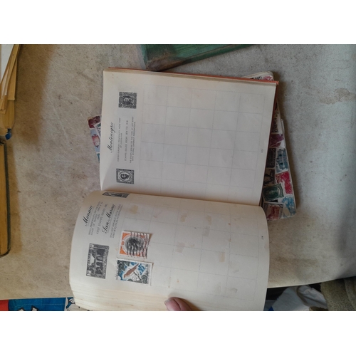 136 - Stamps: a box of stamps albums, ice cream carton of stamps on paper and loose, mixed era world stamp... 