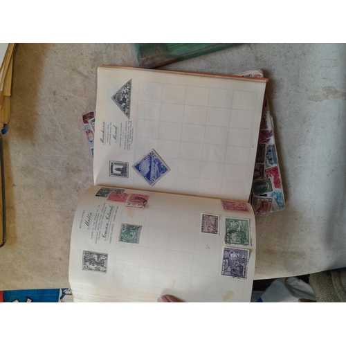 136 - Stamps: a box of stamps albums, ice cream carton of stamps on paper and loose, mixed era world stamp... 