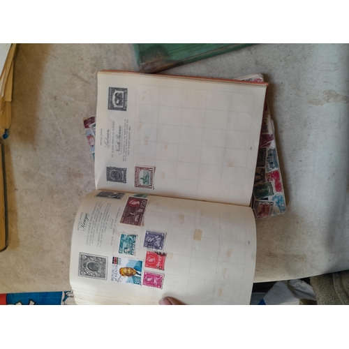 136 - Stamps: a box of stamps albums, ice cream carton of stamps on paper and loose, mixed era world stamp... 