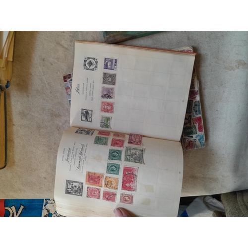 136 - Stamps: a box of stamps albums, ice cream carton of stamps on paper and loose, mixed era world stamp... 