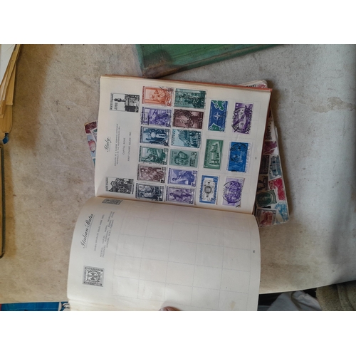 136 - Stamps: a box of stamps albums, ice cream carton of stamps on paper and loose, mixed era world stamp... 